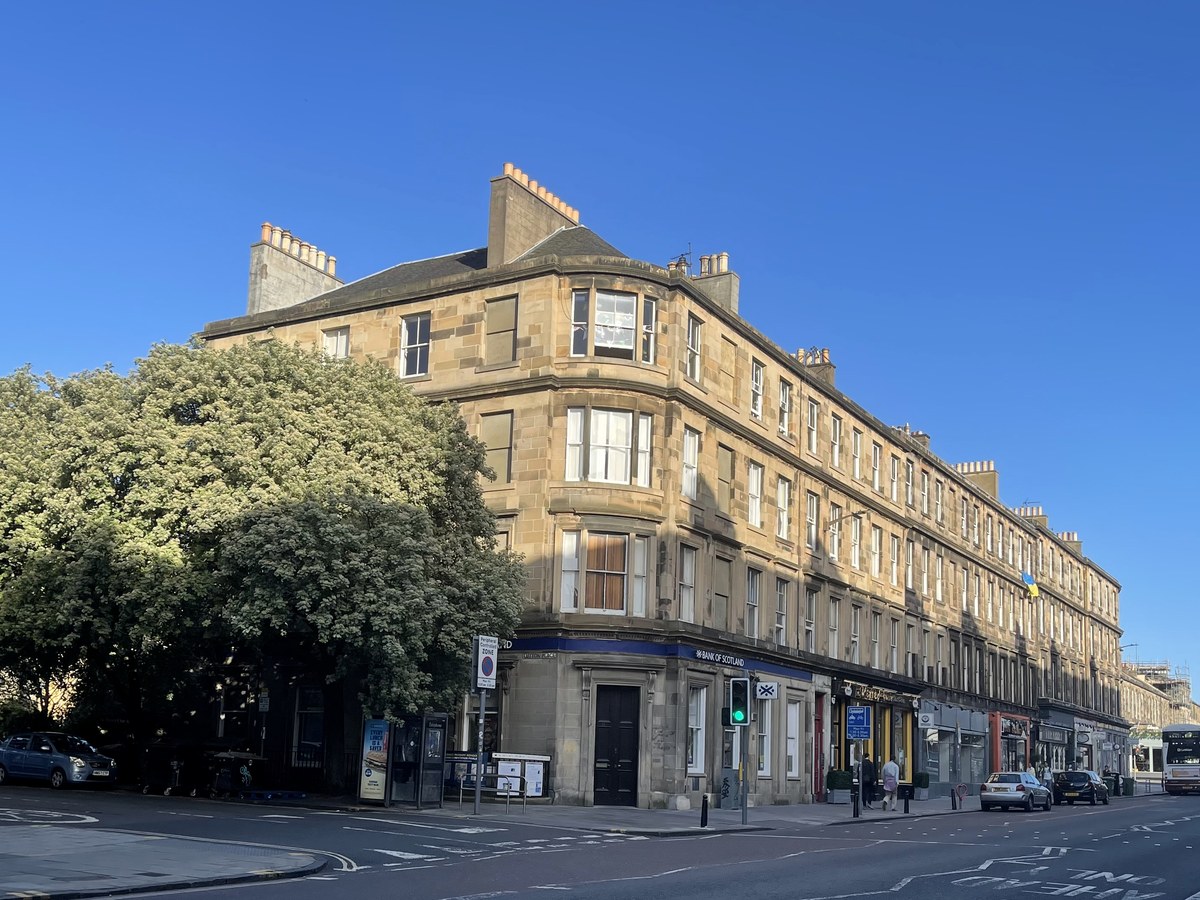 Warm-stone residential tenements on an Edinburgh street